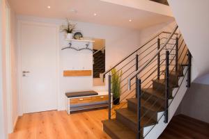 a staircase in a home with wooden floors at Ostsee - Maisonette - Appartement Nr 53 "Schöne Aussicht" im Strand Resort in Heiligenhafen