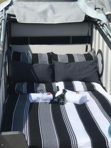 a bed with black and white striped sheets and pillows at Klarsinnchen 4 NEU !!! in Grömitz