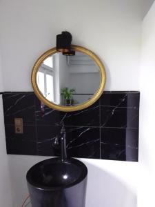 a bathroom with a sink and a mirror at Ferienbahnhof Utzerath in Utzerath