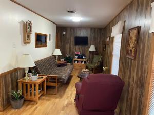 a living room with a couch and a table at PINE VALLEY MOTEL in Spruce Pine