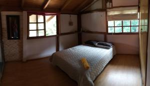 מיטה או מיטות בחדר ב-Posada turística Quenari Wii