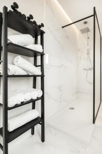 a bathroom with a black towel rack with towels at Villa My Corner in De Panne