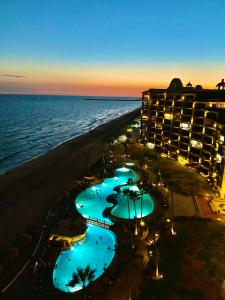 a view of a hotel and the beach at night at Sonoran Sea Resort Oceanfront PENTHOUSE in Puerto Peñasco
