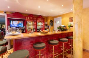 a bar in a restaurant with stools at a counter at Strandhotel Sylt Westerland in Westerland