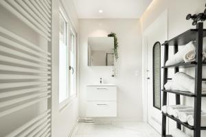 a bathroom with a sink and a mirror at Villa My Corner in De Panne