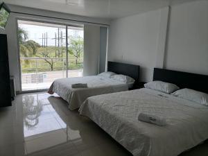 Postel nebo postele na pokoji v ubytování Hotel Cayapo