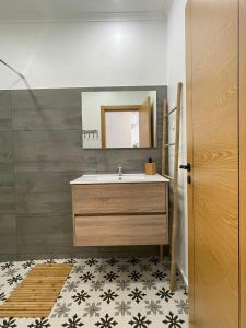 a bathroom with a sink and a mirror at SunsetRiver Studio in Portimão