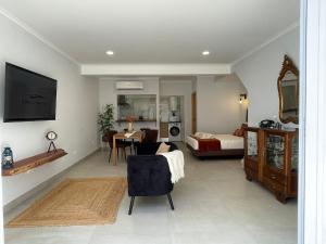 a living room with a table and a bedroom at SunsetRiver Studio in Portimão