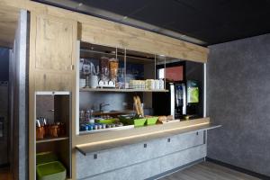 a kitchen with a counter in a room at ibis budget Pontarlier in Pontarlier