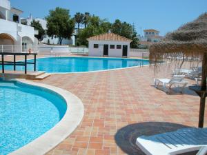a large swimming pool with a brick patio at Baiona Club Villa 19 in Porches