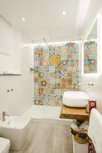 a bathroom with a sink and a shower curtain at Il Moro Boutique Apartment in Catania