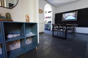 a dining room with a blue cabinet and a table at Modern apt facing St Peter's and Vatican Museums - myPad in Rome in Rome