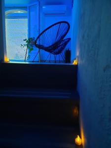 a metal fan sitting on a window sill at night at Maison avec jacuzzi in Saint-Mitre-les-Remparts