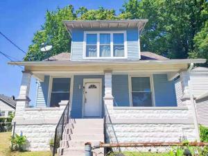 a blue house with a white door at Private Room Near to Downtown Churchill Downs UofL Airport &Kentucky Expo Center in Louisville