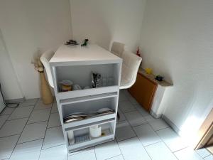 a small white table and chair in a room at Haus Alexandra in Rust