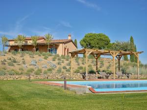 a house with a swimming pool in front of a house at Poggio Tamantino, Villa con piscina in Maremma in Poggio Cavallo