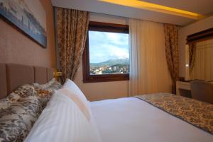 Postel nebo postele na pokoji v ubytování Imamoglu Pasa Butik Hotel