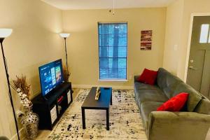 a living room with a couch and a television at Woodlands House - FREE Parking & Fast WiFi - 3 Bed. 1,5 Bath in The Woodlands