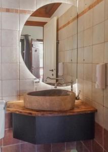 a bathroom with a sink with a large mirror at Ninemia Stay and Play in Karpenision +89 photos