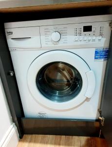 a washing machine sitting in a room at Superb 2 beds 2 baths New Apartment w/ Garden+Patio in Bournemouth
