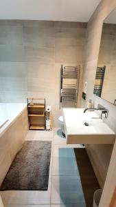 a bathroom with a sink and a toilet at Superb 2 beds 2 baths New Apartment w/ Garden+Patio in Bournemouth +24 photos