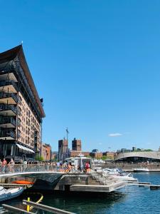 a bridge over a river with boats in the water at Budget Little Room with Window City Centre Oslo in Oslo