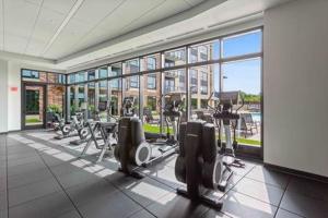 a gym with treadmills and ellipticals in a building at The Berkman in Rochester