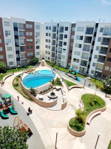 an apartment complex with a pool and a playground at Dpto 3 hab en Piura - GARDEN 360~ in Piura