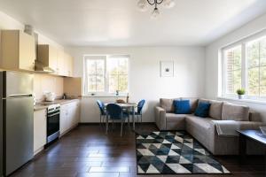 a kitchen and a living room with a couch and a table at 3 Apartment Between Two Lakes in Vilnius