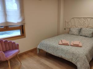 a bedroom with a bed with two towels on it at Apartamento Juan de Herrera VUT47168 in Valladolid