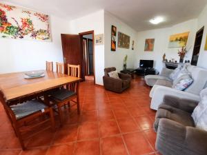 a living room with a table and a couch at Villa Quinta do Algarve in Albufeira