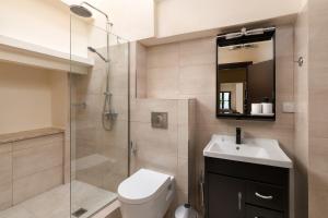a bathroom with a shower and a toilet and a sink at To Rodi Apartments in Rhodes Town
