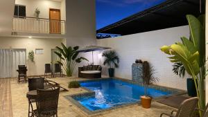 a swimming pool in the middle of a house at Ventanas Hotel Boutique in Carolina