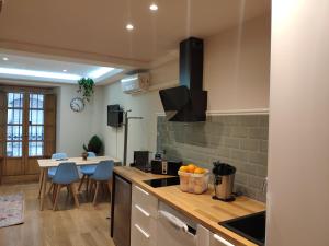 a kitchen with a counter and a table with chairs at Apartamento Juan de Herrera VUT47168 in Valladolid