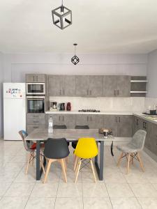 a kitchen with a table and chairs and a refrigerator at Nafplio Boutique Apartment in Nafplio