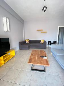 a living room with a couch and a coffee table at Nafplio Boutique Apartment in Nafplio