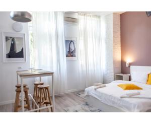Un dormitorio con una cama, una mesa y un escritorio. en Modern Studio in the Heart of Iasi, en Iaşi