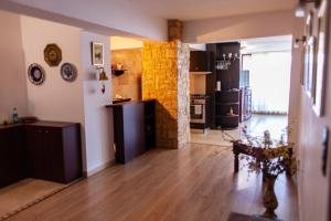 a living room with a wooden floor and a kitchen at Spacious Apartment in City Centre in Iaşi +32 photos