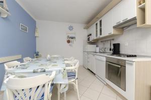 a kitchen with a table and chairs in a room at House Mia in Trogir