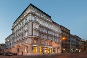 a large brick building on the corner of a street at Hotel Suite Home Prague in Prague