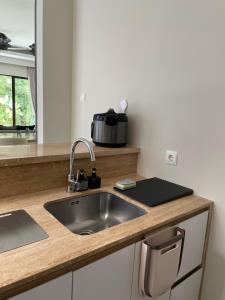 a kitchen counter with a sink and a microwave at The Pines Vimala Hills in Bogor