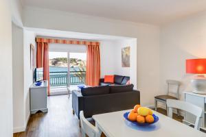 a living room with a couch and a table at Lili Apartments in Port de Soller