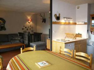 a kitchen and a living room with a table and chairs at Appartement Villard-de-Lans, 3 pièces, 6 personnes - FR-1-515-9 in Villard-de-Lans