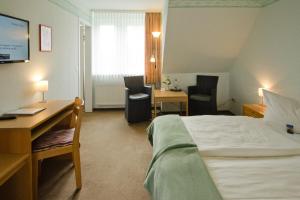 Hotel Harz tesisinde bir odada yatak veya yataklar