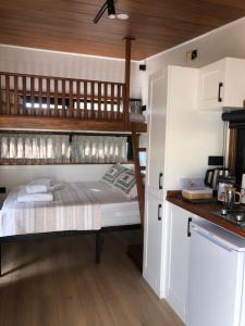 a bedroom with two bunk beds in a kitchen at Tiny house kayaköy Nar in Fethiye