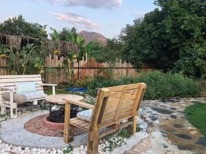 a wooden bench and a table in a garden at Tiny house kayaköy Nar in Fethiye