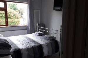 a bedroom with a bed with towels on it at Lovely 1-Bed Apartment at Whitepark Bay Co Antrim in Bushmills