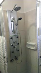 a shower in a bathroom with a glass door at Villa Konaki in Grammatiko +30 photos