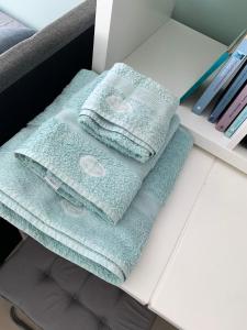 two towels sitting on top of a table at Confidential apartment, Prime Location in Athens