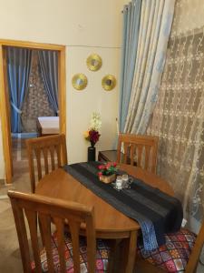 a dining room table with two chairs and a table and a mirror at Entire Apartment 2bed Condo at Burban Oakwood in Bhurban +17 photos